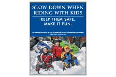 Vertical Poster of Snowmobilers and text ‘Slow Down When Riding With Kids. Keep Them Safe. Make it Fun.'