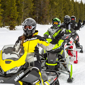 snowmobilers signaling on trail