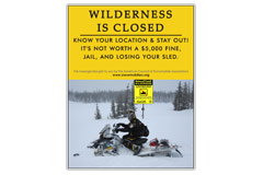 Vertical Poster of Snowmobilers and text ‘Wilderness is Closed. Know your Location and Stay Out. It's not worth a $5,000 fine,  jail, and losing your sled.